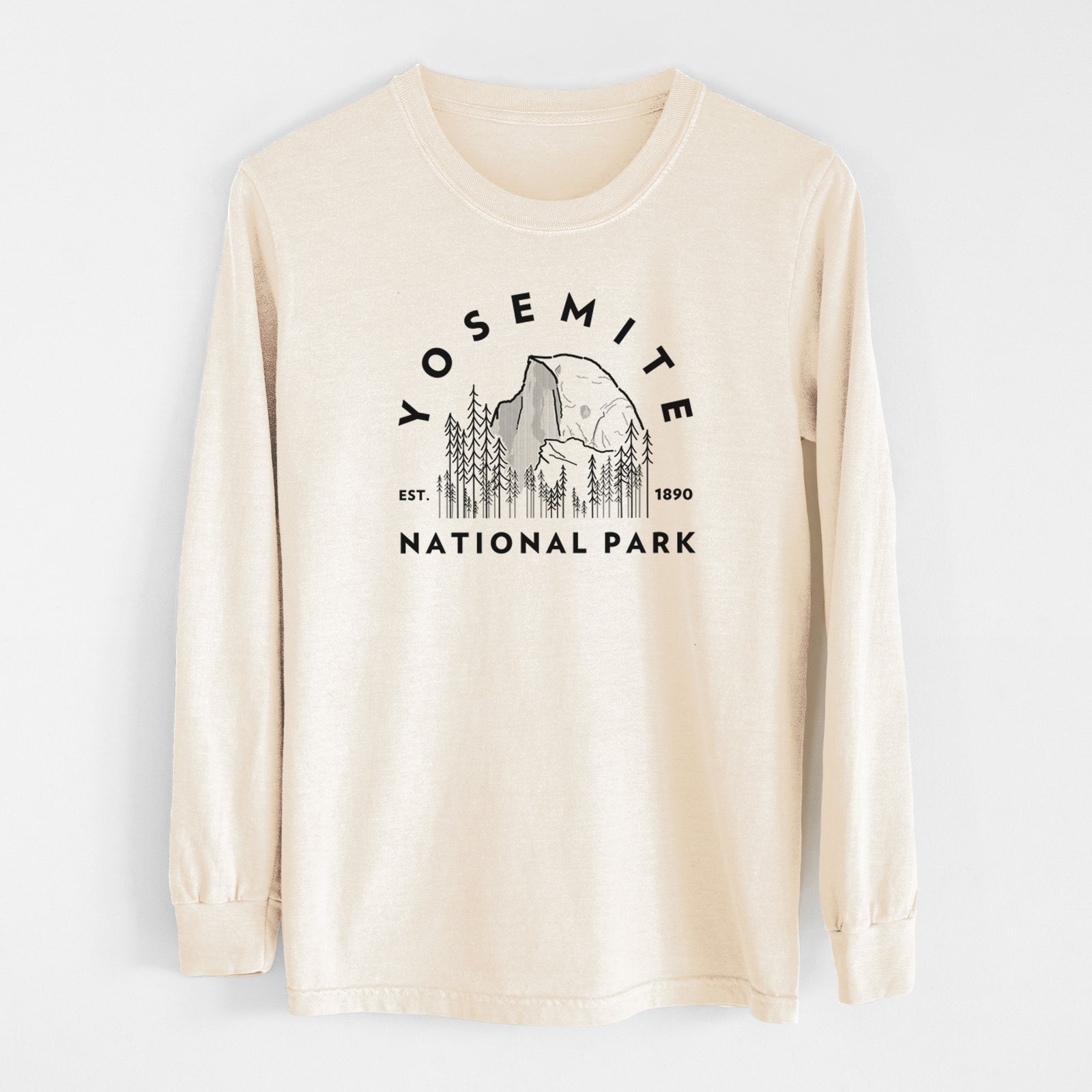 Ivory Comfort Colors long sleeve shirt laid flat, printed with a round badge of Half Dome and pine trees, with the words Yosemite National Park, Est. 1890.