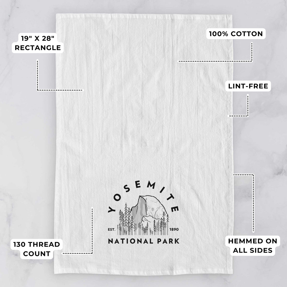 White tea towel printed with a round badge of Half Dome and pine trees, with the words Yosemite National Park, Est. 1890, with feature labels: 19 by 28 inch rectangle, 100% cotton, lint-free, 130 thread count, hemmed on all sides.