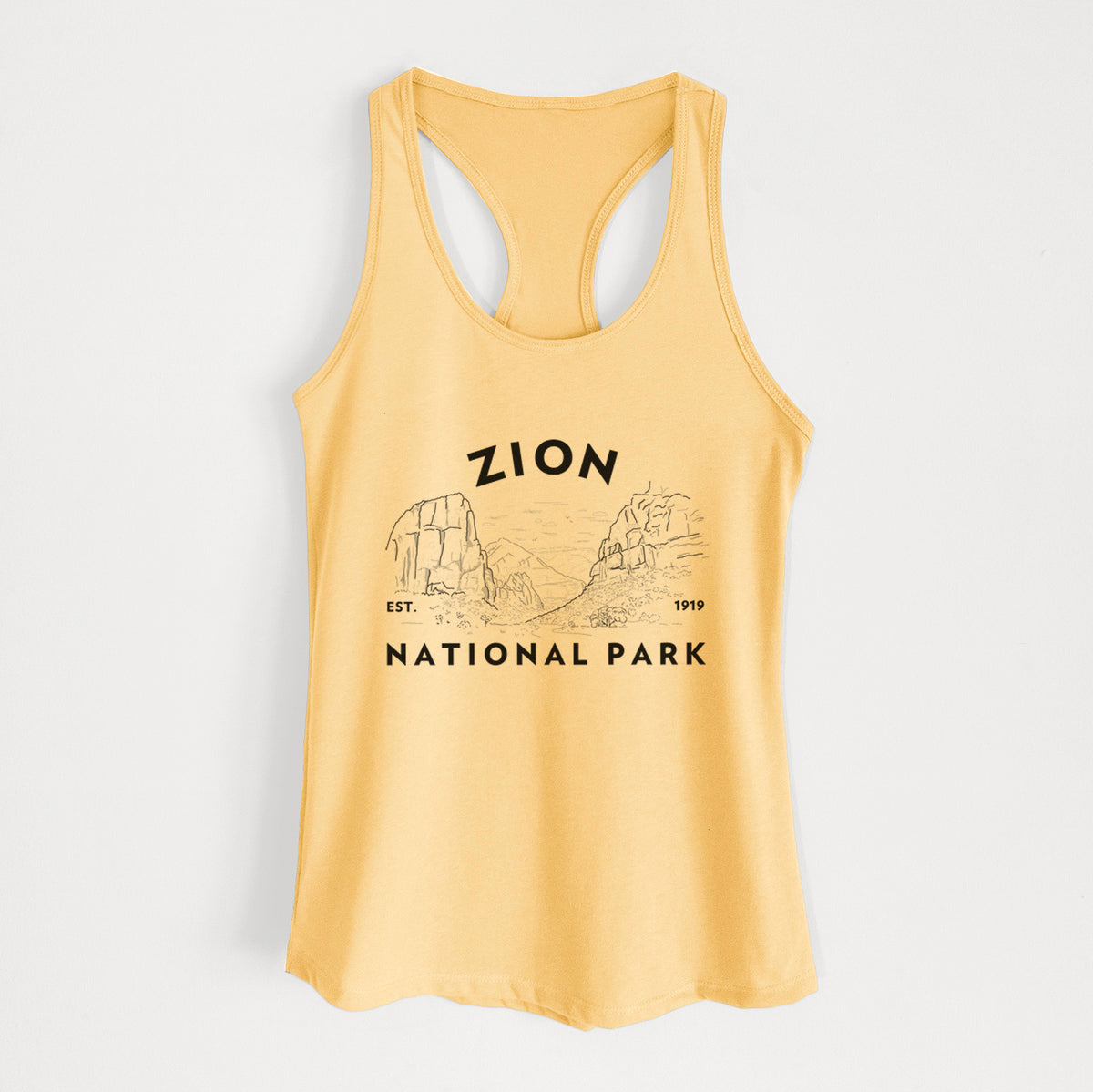 Banana cream women's racerback tank top laid flat, printed with a round badge of canyon walls, with the words Zion National Park, Est. 1919.
