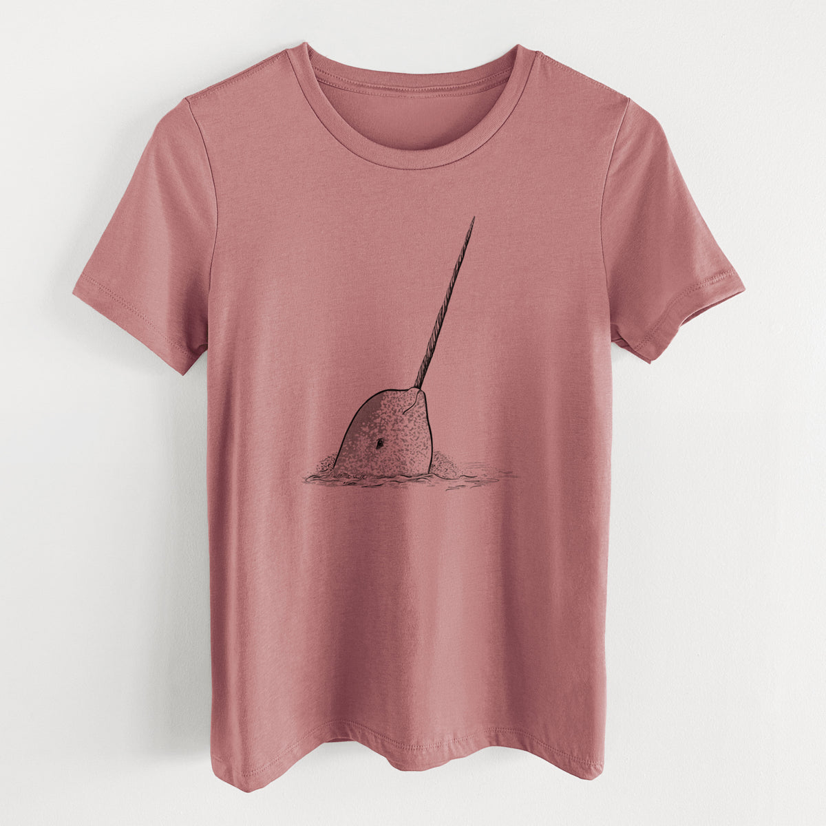 Mauve pink women's relaxed fit cotton t-shirt laid flat, printed with a black ink illustration of a narwhal with its long spiral tusk pointing upward.
