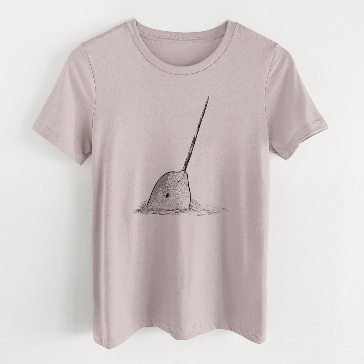 Pink gravel women's relaxed fit cotton t-shirt laid flat, printed with a black ink illustration of a narwhal with its long spiral tusk pointing upward.