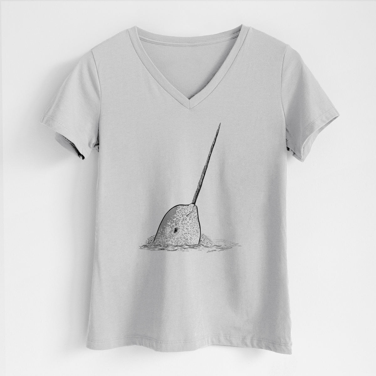 Lunar grey women's relaxed fit cotton V-neck t-shirt laid flat, printed with a black ink illustration of a narwhal with its long spiral tusk pointing upward.