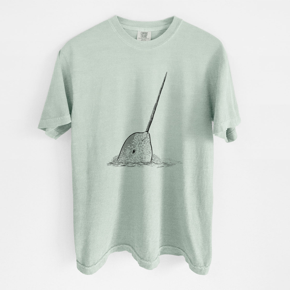 Bay green Comfort Colors t-shirt laid flat, printed with a black ink illustration of a narwhal with its long spiral tusk pointing upward.
