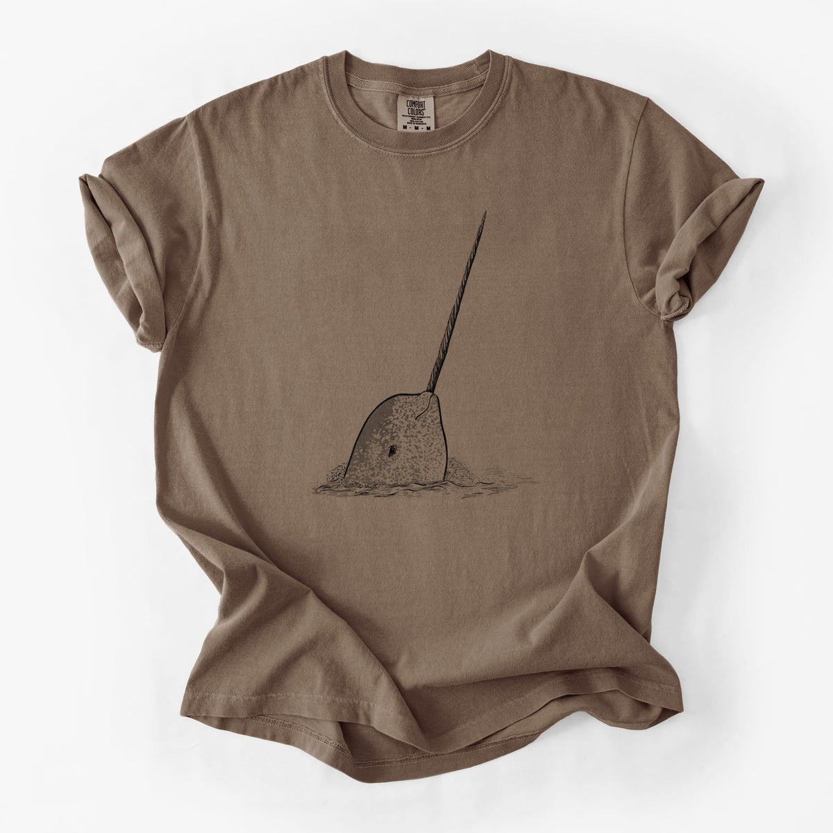 Espresso brown Comfort Colors t-shirt laid flat, printed with a black ink illustration of a narwhal with its long spiral tusk pointing upward.