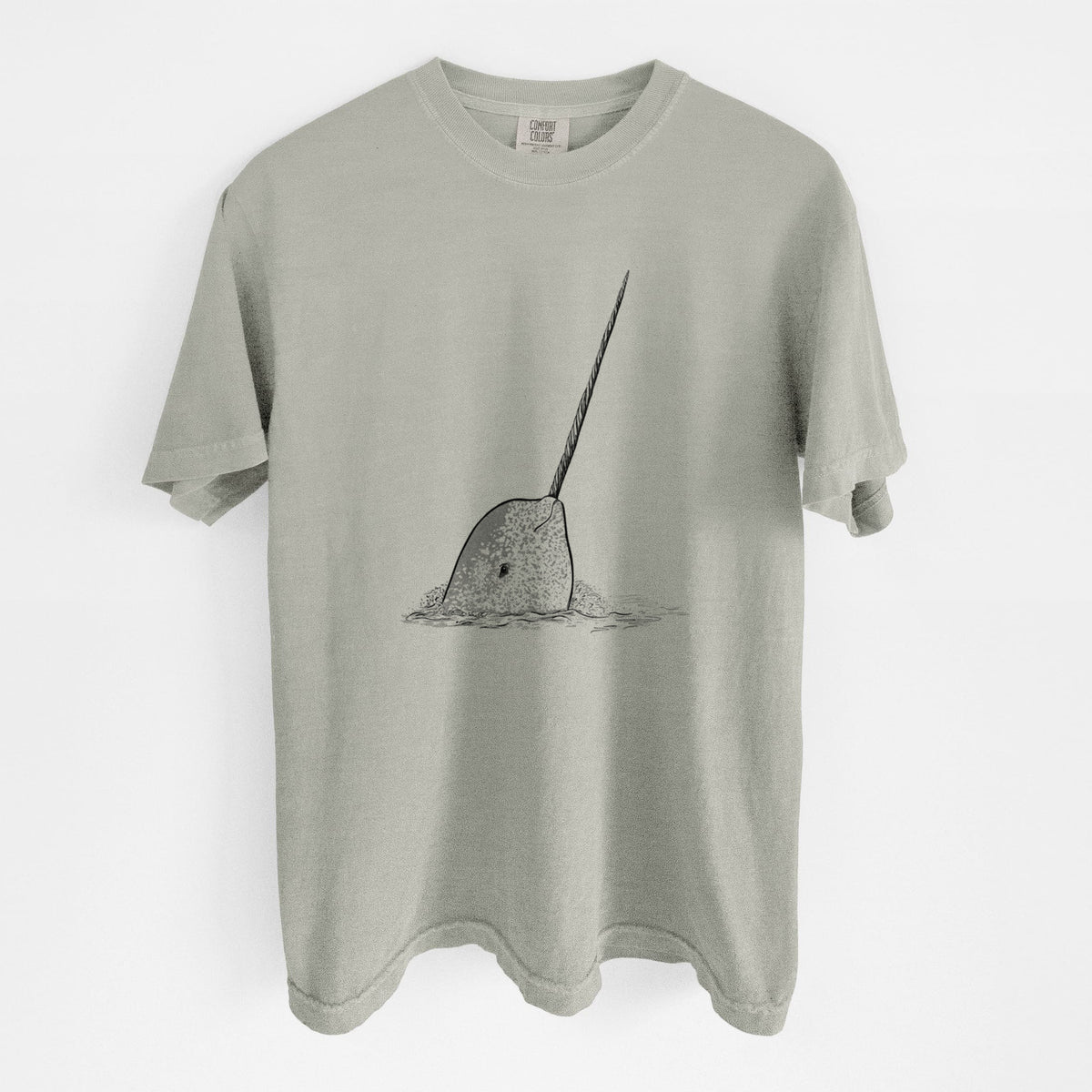 Sandstone beige Comfort Colors t-shirt laid flat, printed with a black ink illustration of a narwhal with its long spiral tusk pointing upward.