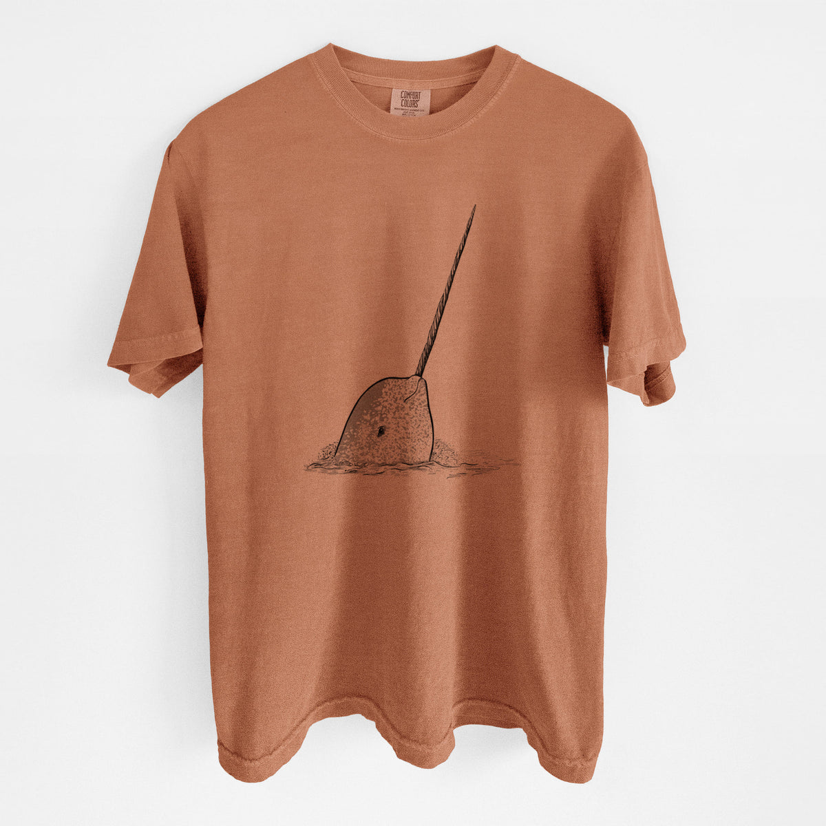 Yam burnt orange Comfort Colors t-shirt laid flat, printed with a black ink illustration of a narwhal with its long spiral tusk pointing upward.