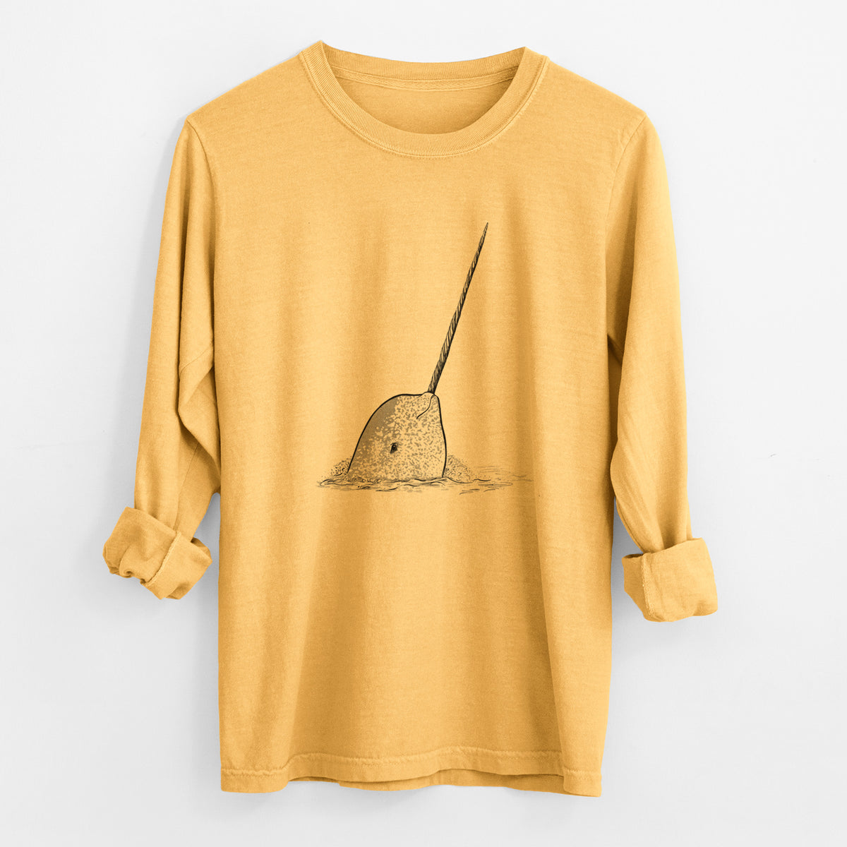 Golden wheat yellow Comfort Colors long sleeve shirt laid flat with the cuffs rolled, printed with a black ink illustration of a narwhal with its long spiral tusk pointing upward.