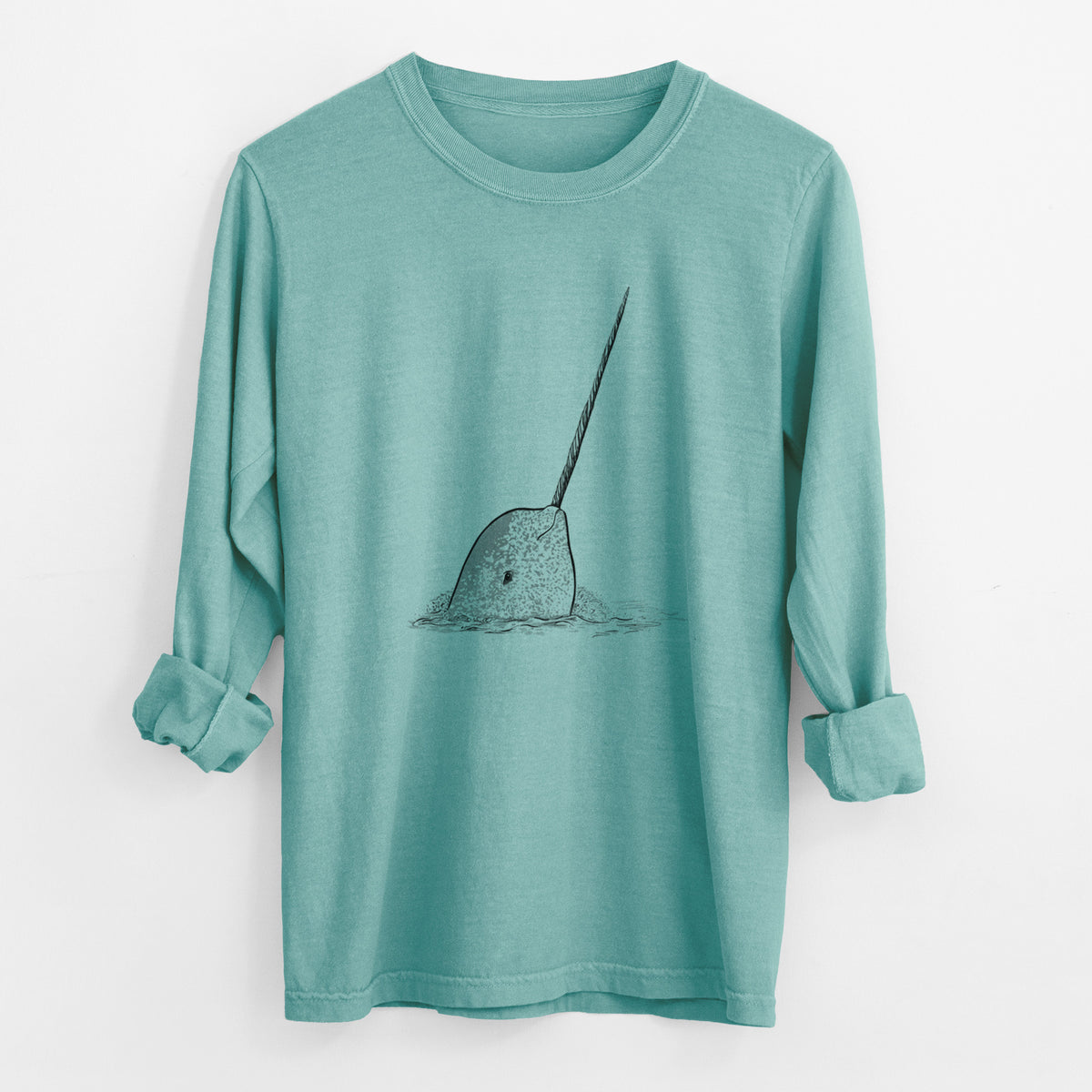 Reef green Comfort Colors long sleeve shirt laid flat with the cuffs rolled, printed with a black ink illustration of a narwhal with its long spiral tusk pointing upward.