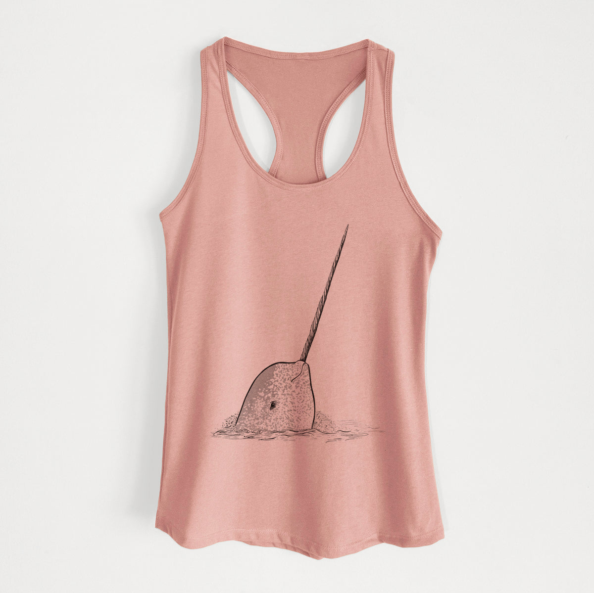 Desert pink women's racerback tank top laid flat, printed with a black ink illustration of a narwhal with its long spiral tusk pointing upward.