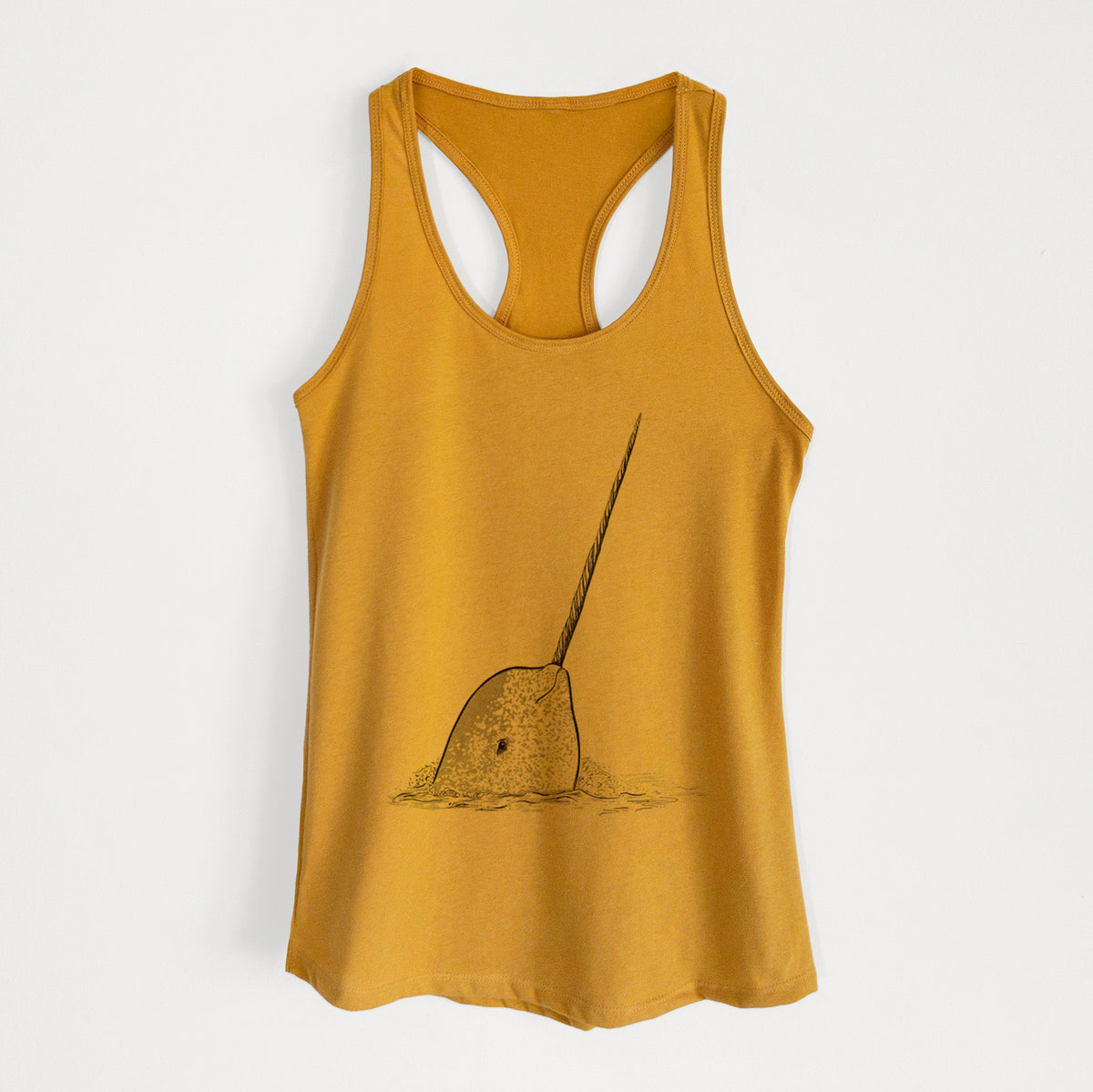 Gold women's racerback tank top laid flat, printed with a black ink illustration of a narwhal with its long spiral tusk pointing upward.
