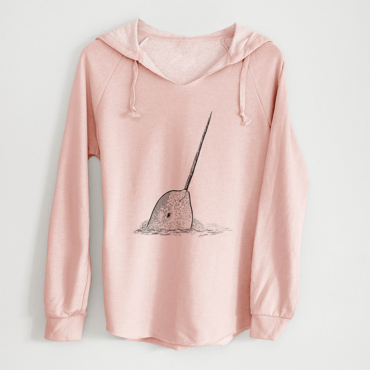 Blush pink women's Cali Wave hooded sweatshirt laid flat, printed with a black ink illustration of a narwhal with its long spiral tusk pointing upward.