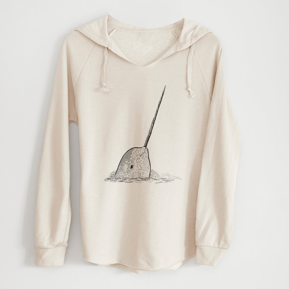 Bone cream women's Cali Wave hooded sweatshirt laid flat, printed with a black ink illustration of a narwhal with its long spiral tusk pointing upward.