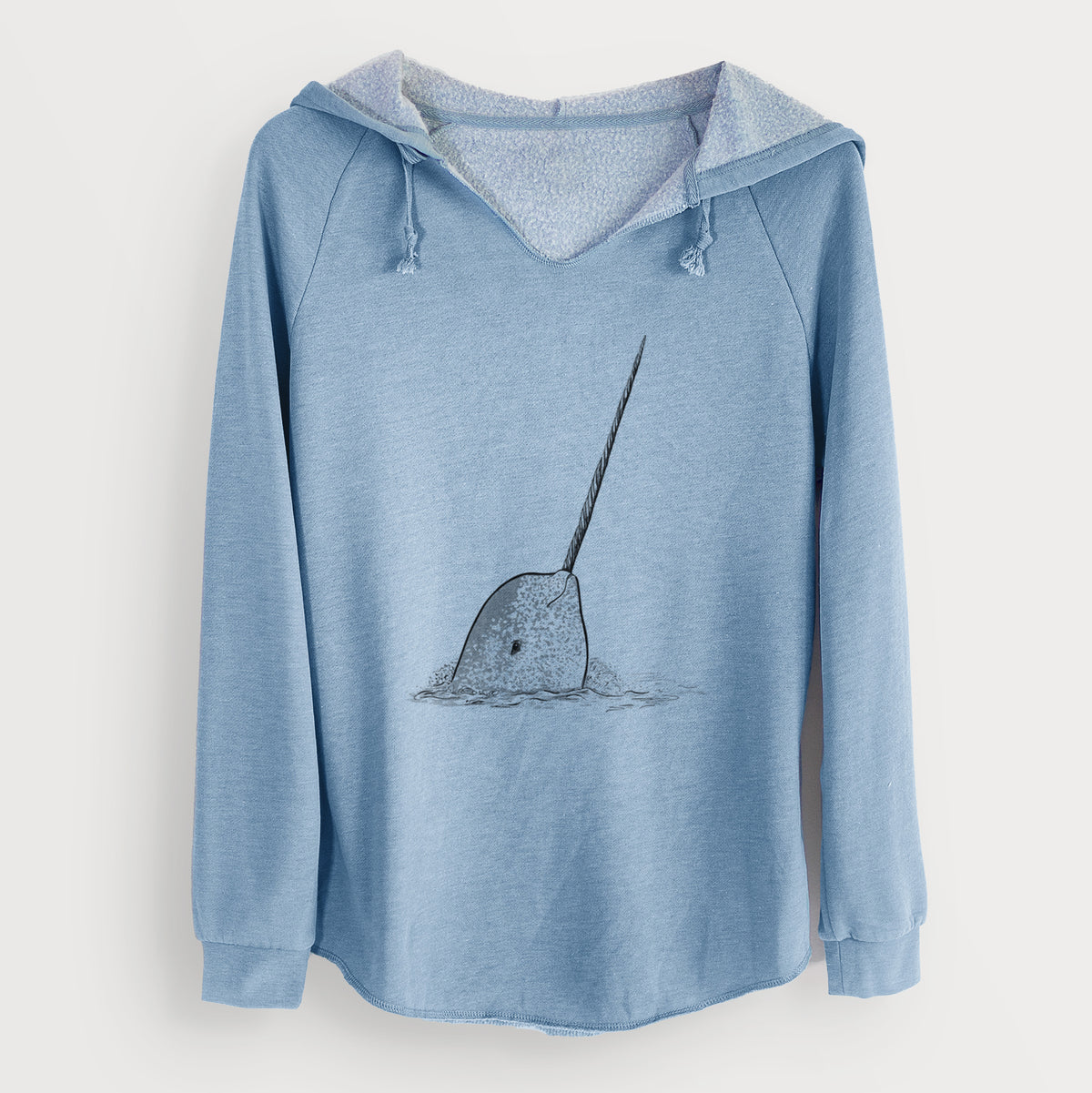 Misty blue women's Cali Wave hooded sweatshirt laid flat, printed with a black ink illustration of a narwhal with its long spiral tusk pointing upward.