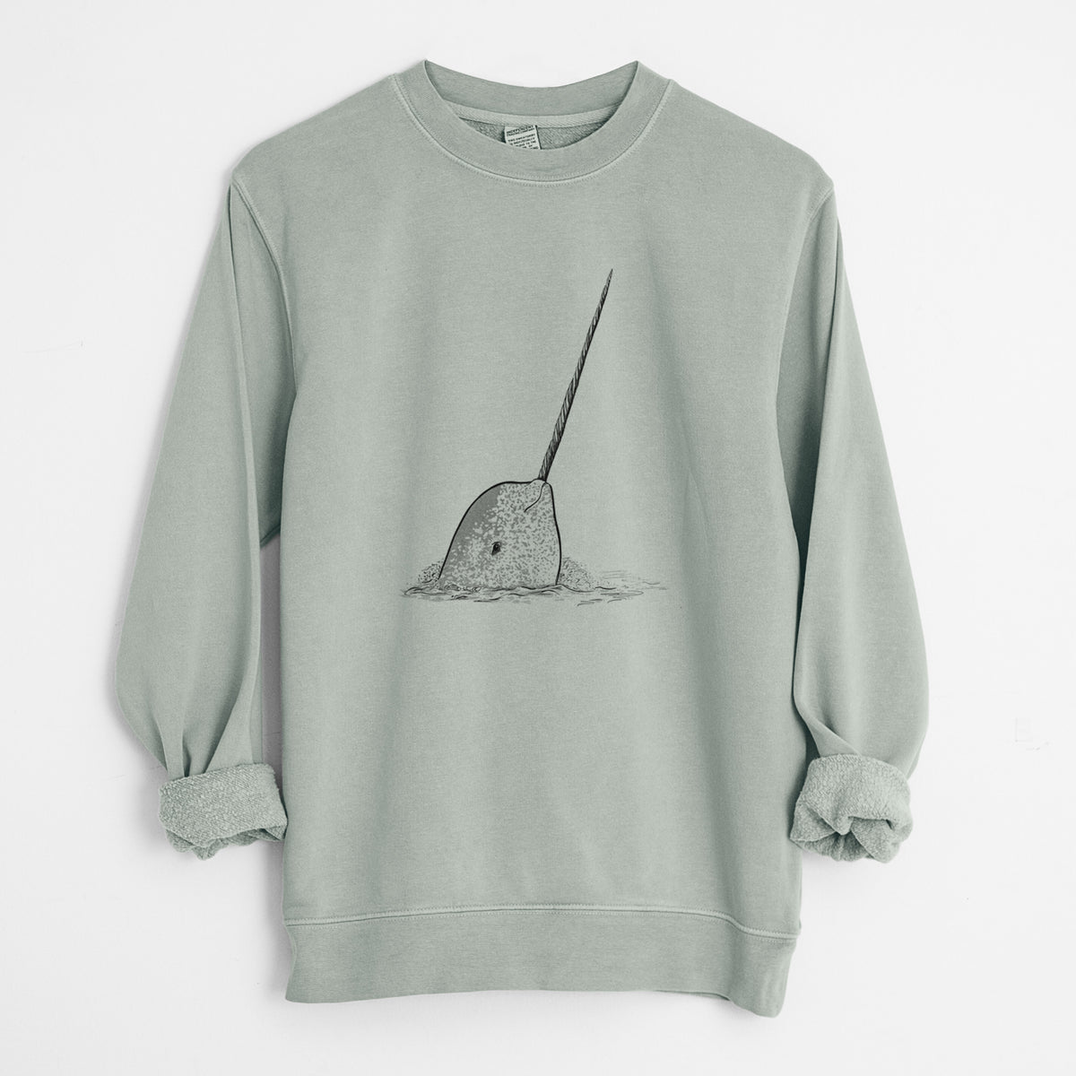 Sage green pigment dyed crewneck sweatshirt laid flat with the sleeves rolled, printed with a black ink illustration of a narwhal with its long spiral tusk pointing upward.