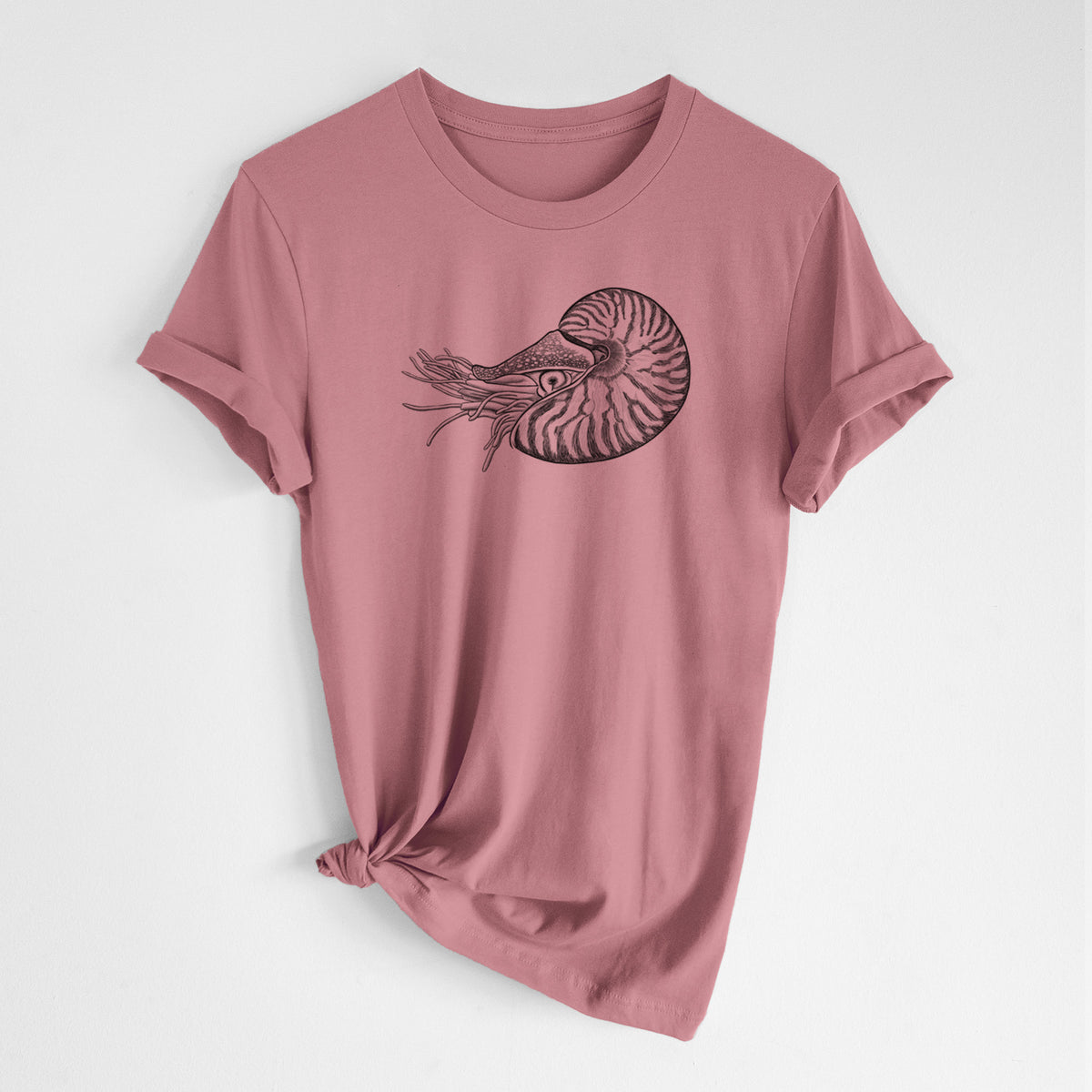 Mauve pink lightweight cotton t-shirt laid flat with the sleeves rolled, printed with a detailed black ink illustration of a chambered nautilus with its striped spiral shell and tentacles.