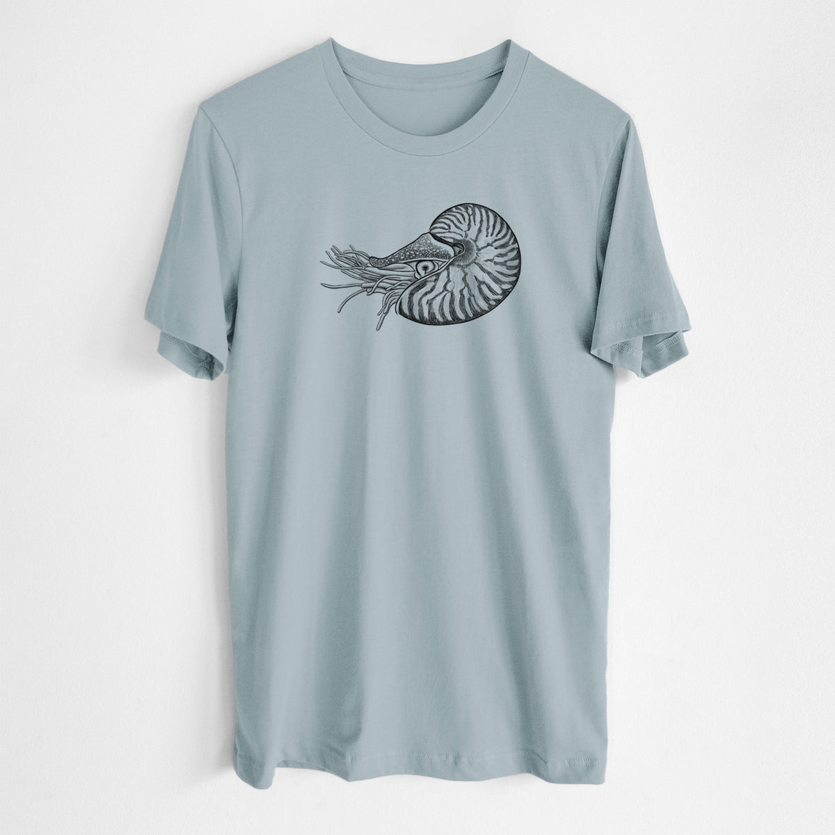 Vintage denim lightweight cotton t-shirt laid flat, printed with a detailed black ink illustration of a chambered nautilus with its striped spiral shell and tentacles.