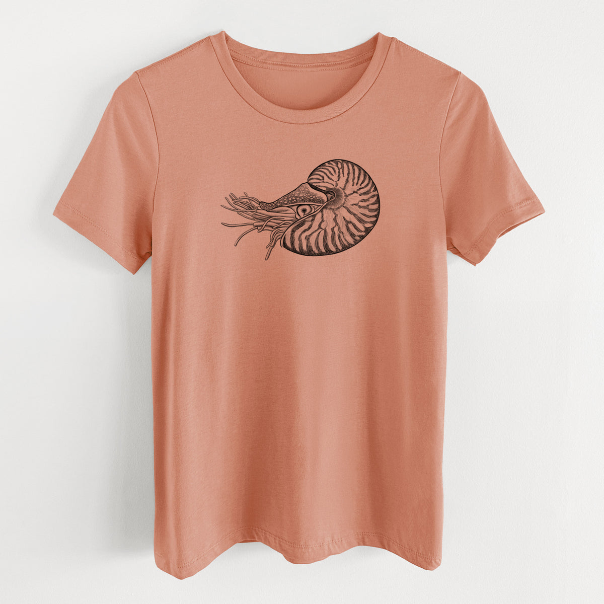Terracotta orange women's relaxed fit cotton t-shirt laid flat, printed with a detailed black ink illustration of a chambered nautilus with its striped spiral shell and tentacles.