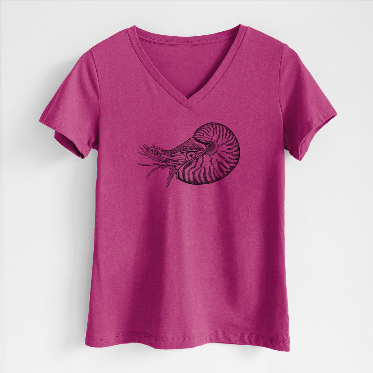 Berry pink women's relaxed fit cotton V-neck t-shirt laid flat, printed with a detailed black ink illustration of a chambered nautilus with its striped spiral shell and tentacles.