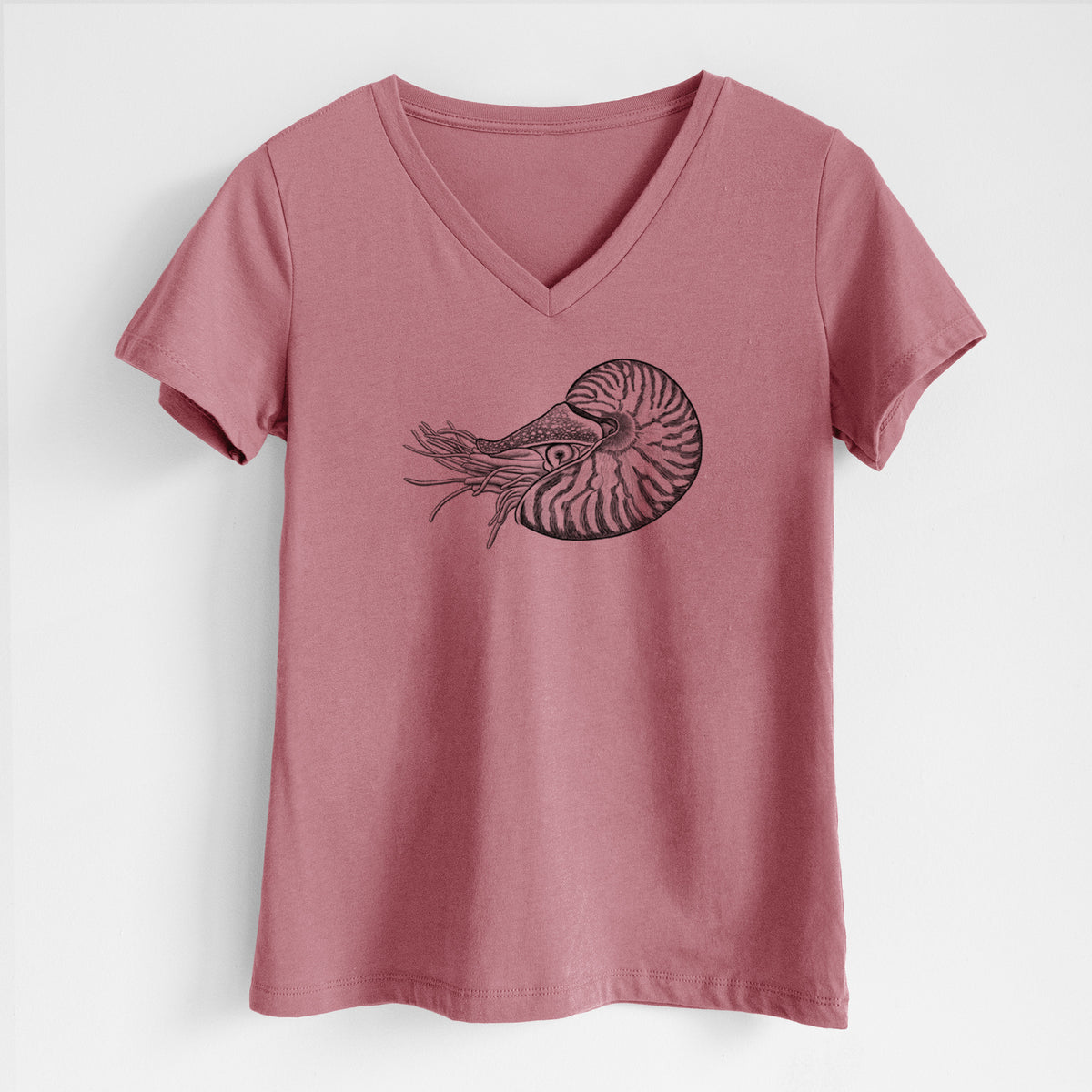 Mauve pink women's relaxed fit cotton V-neck t-shirt laid flat, printed with a detailed black ink illustration of a chambered nautilus with its striped spiral shell and tentacles.