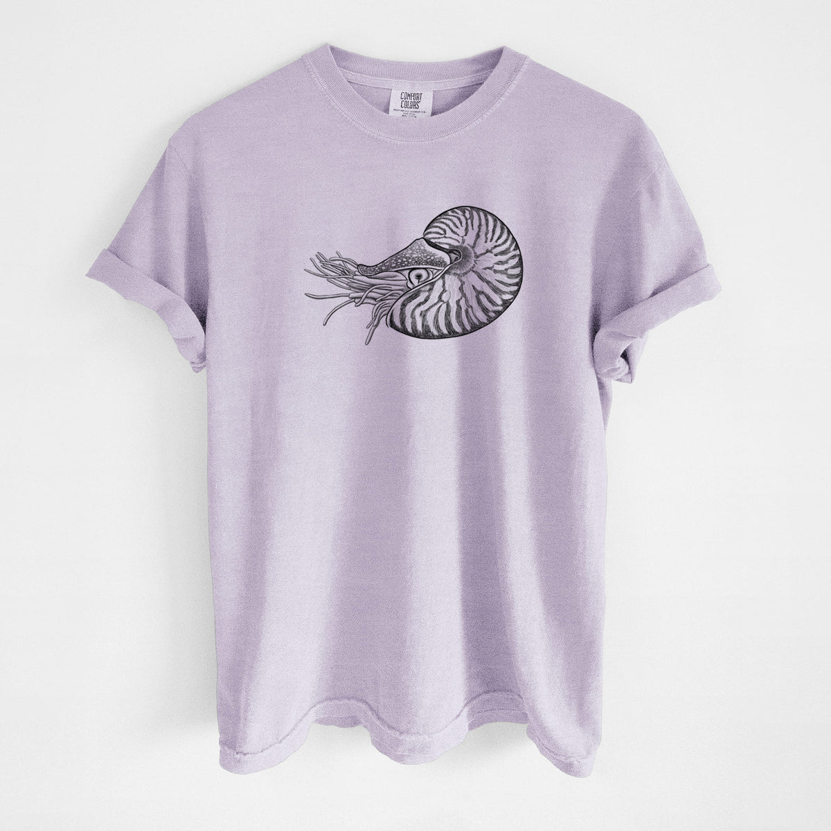 Orchid purple Comfort Colors t-shirt laid flat, printed with a detailed black ink illustration of a chambered nautilus with its striped spiral shell and tentacles.