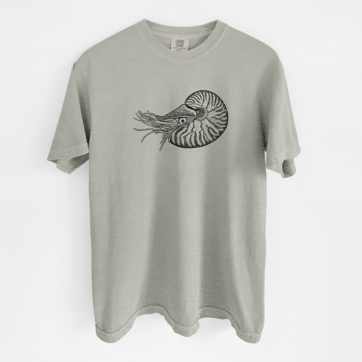 Sandstone beige Comfort Colors t-shirt laid flat, printed with a detailed black ink illustration of a chambered nautilus with its striped spiral shell and tentacles.