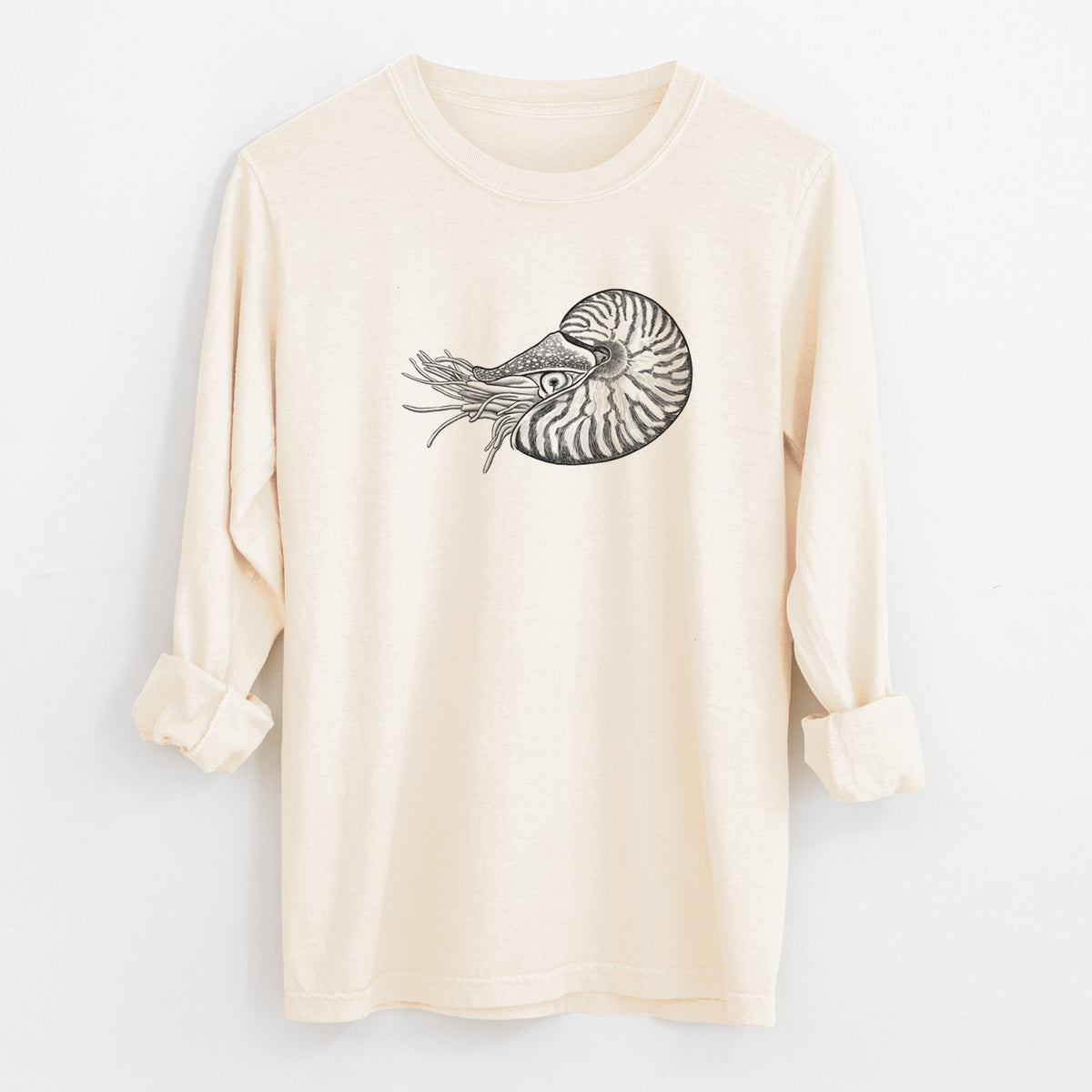 Ivory Comfort Colors long sleeve shirt laid flat with the cuffs rolled, printed with a detailed black ink illustration of a chambered nautilus with its striped spiral shell and tentacles.