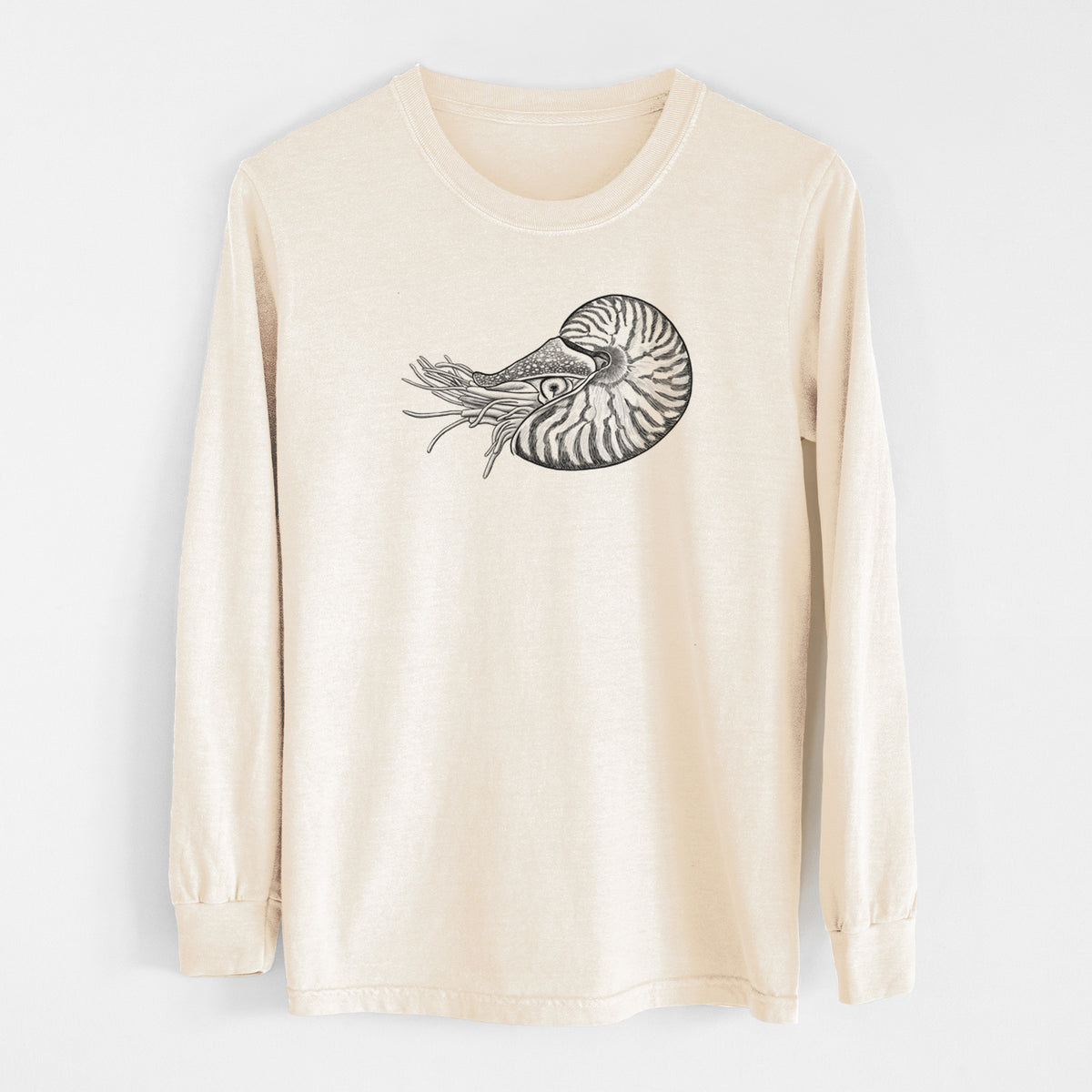 Ivory Comfort Colors long sleeve shirt laid flat, printed with a detailed black ink illustration of a chambered nautilus with its striped spiral shell and tentacles.