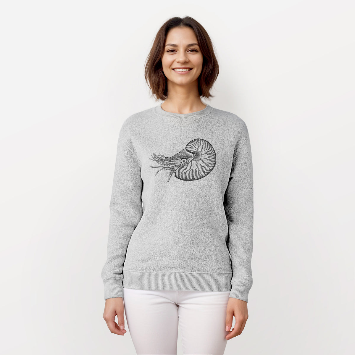 Woman wearing a knit sweatshirt printed with a detailed black ink illustration of a chambered nautilus with its striped spiral shell and tentacles.