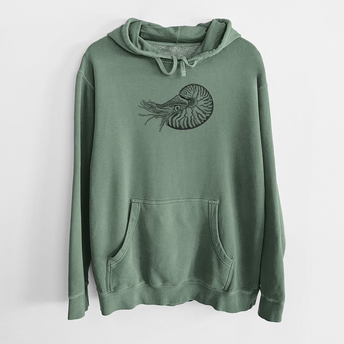 Alpine green pigment dyed hoodie laid flat, printed with a detailed black ink illustration of a chambered nautilus with its striped spiral shell and tentacles.