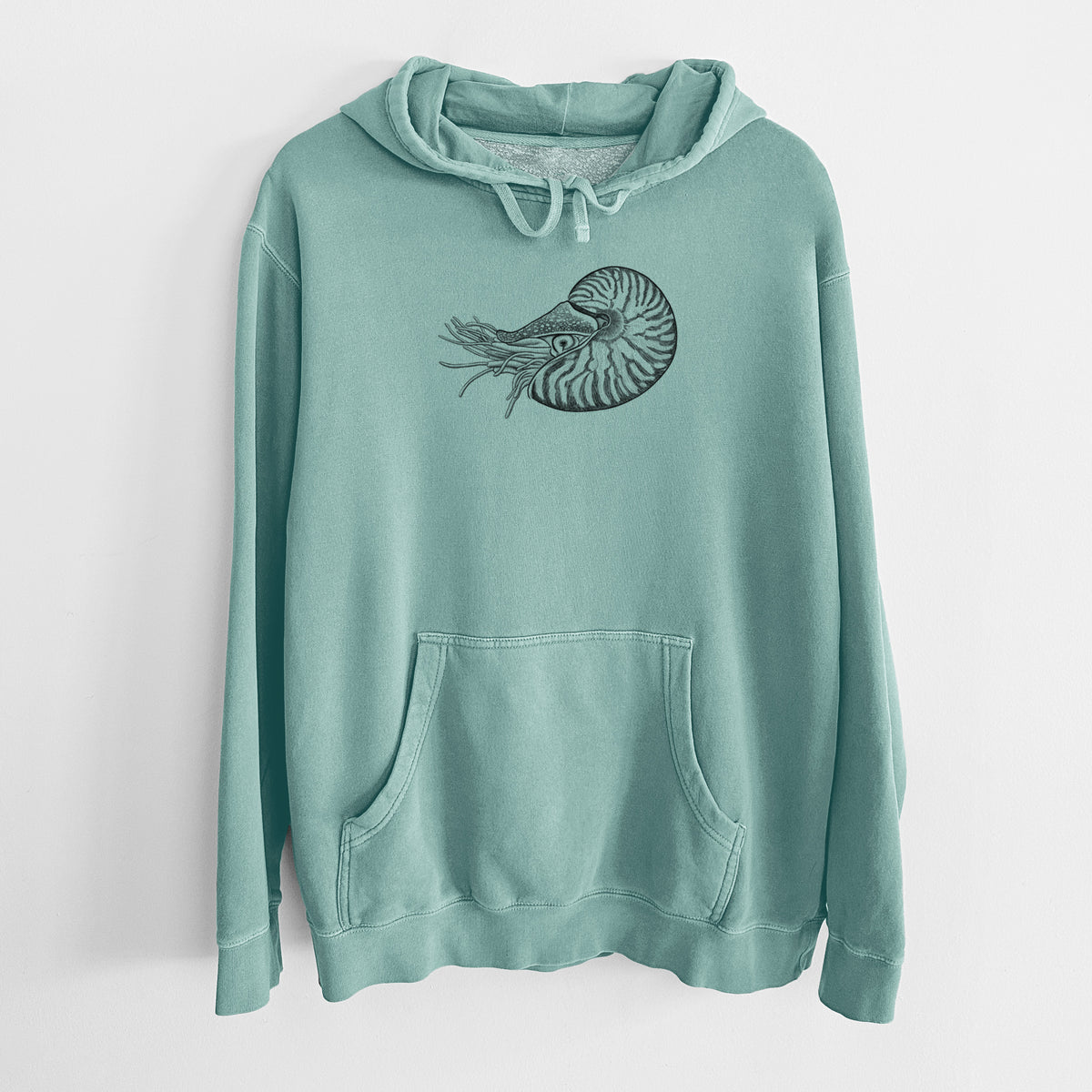 Mint green pigment dyed hoodie laid flat, printed with a detailed black ink illustration of a chambered nautilus with its striped spiral shell and tentacles.