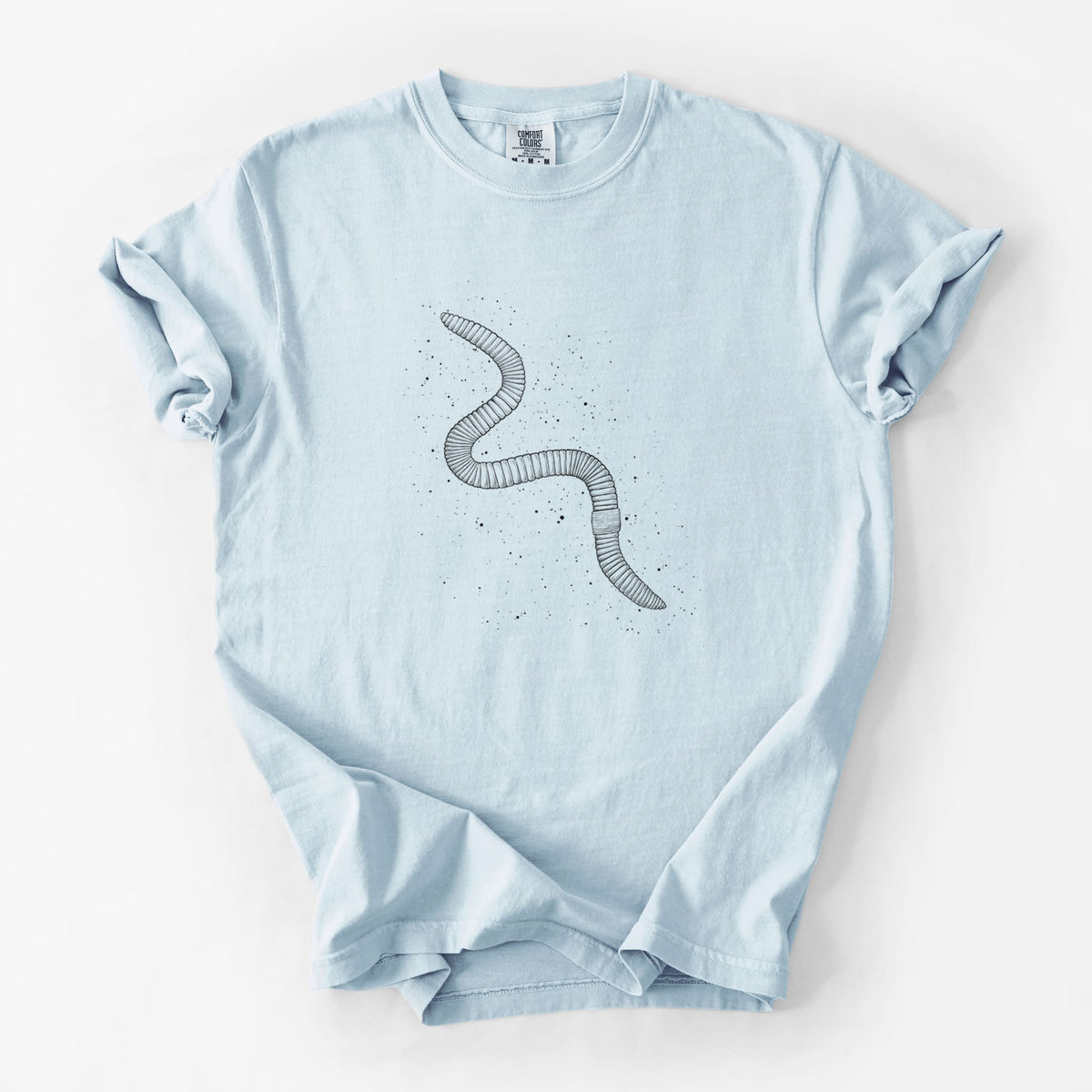 Chambray blue Comfort Colors t-shirt laid flat, printed with a black ink illustration of a nightcrawler earthworm with soil specks.