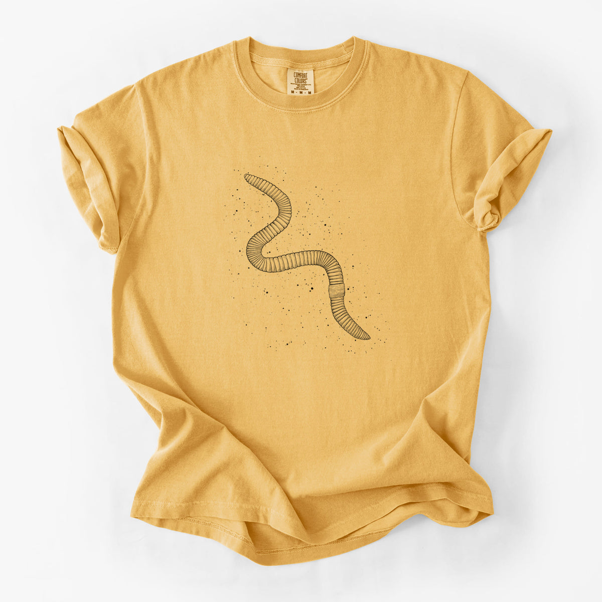 Golden wheat yellow Comfort Colors t-shirt laid flat, printed with a black ink illustration of a nightcrawler earthworm with soil specks.
