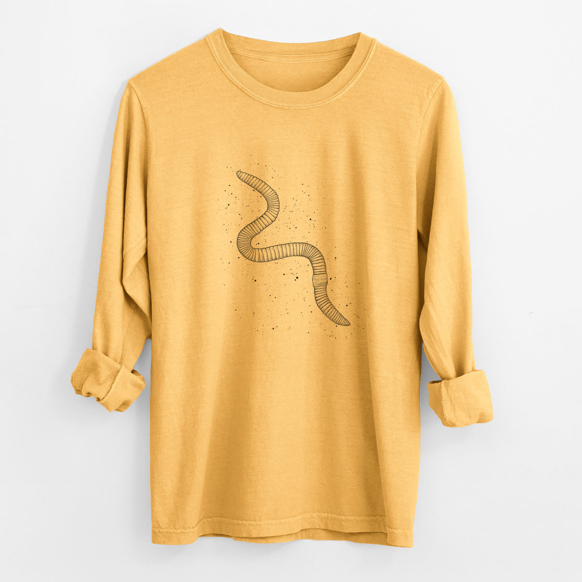 Golden wheat yellow Comfort Colors long sleeve shirt laid flat with the cuffs rolled, printed with a black ink illustration of a nightcrawler earthworm with soil specks.