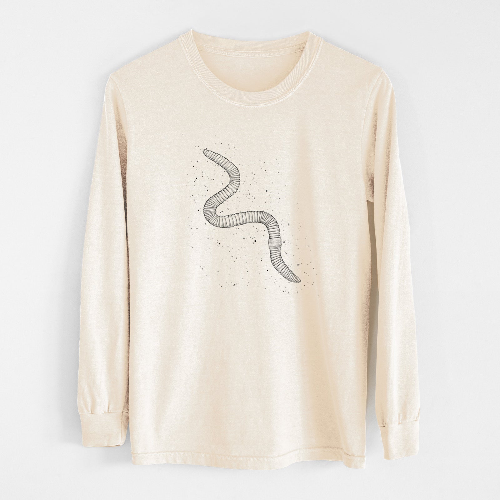 Ivory Comfort Colors long sleeve shirt laid flat, printed with a black ink illustration of a nightcrawler earthworm with soil specks.