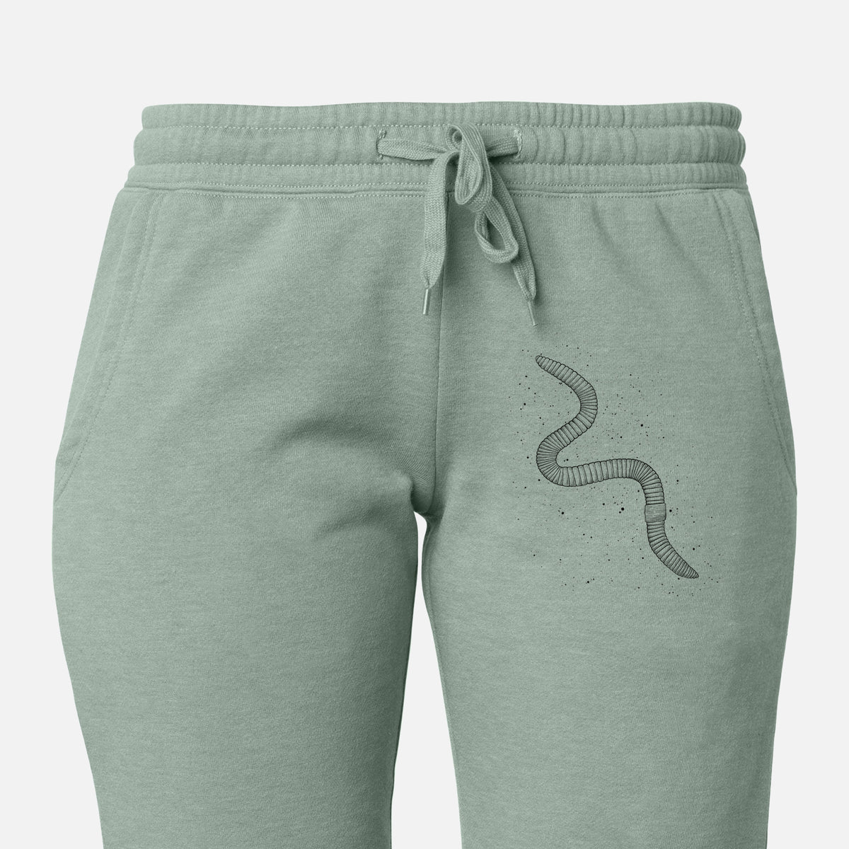 Front of sage green Cali Wave sweatpants, printed with a black ink illustration of a nightcrawler earthworm with soil specks on the leg.
