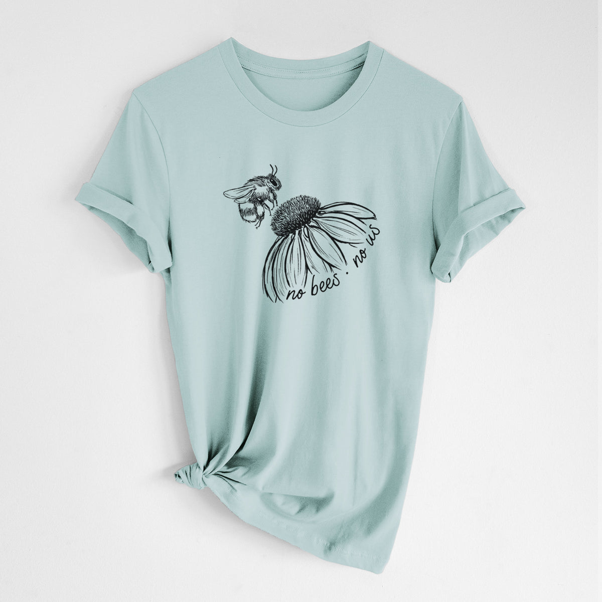 Dusty blue lightweight cotton t-shirt laid flat with the sleeves rolled, printed with a black ink illustration of a bee flying toward a coneflower, with the handwritten words no bees no us.