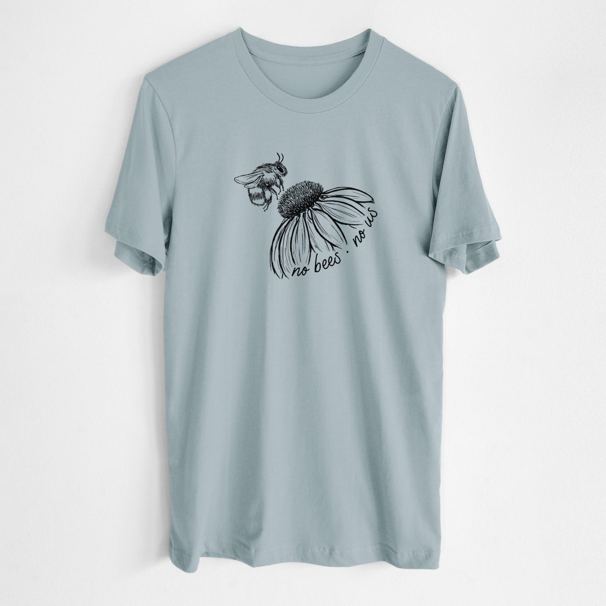 Vintage denim lightweight cotton t-shirt laid flat, printed with a black ink illustration of a bee flying toward a coneflower, with the handwritten words no bees no us.