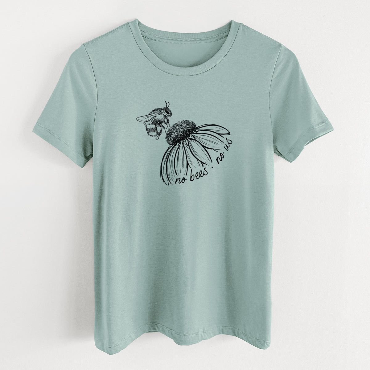 Dusty blue women's relaxed fit cotton t-shirt laid flat, printed with a black ink illustration of a bee flying toward a coneflower, with the handwritten words no bees no us.