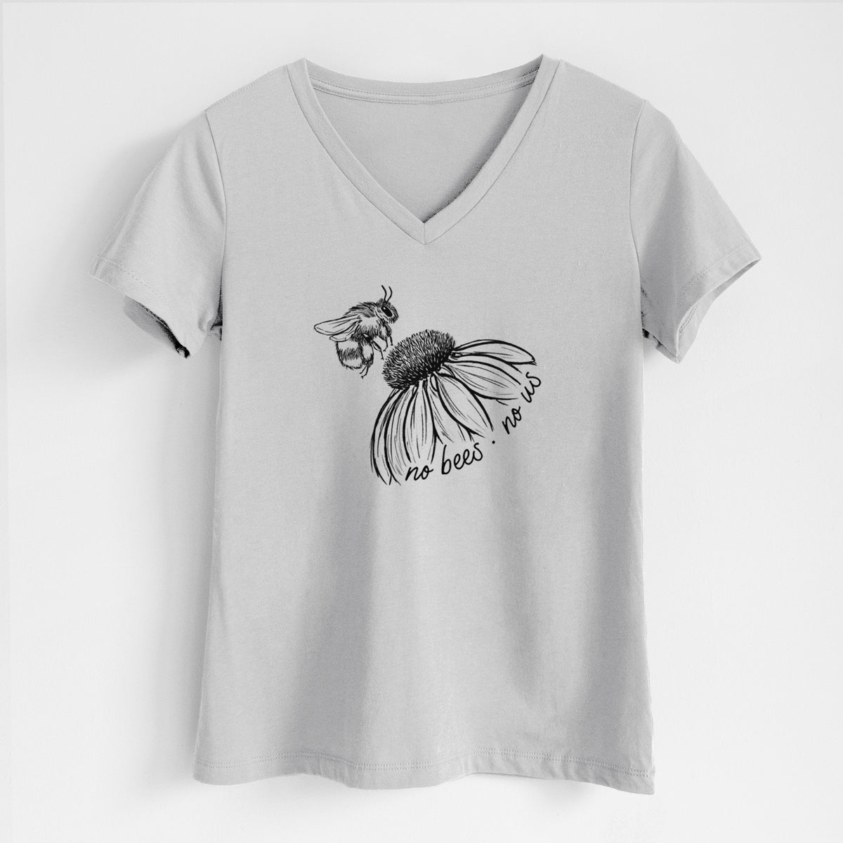 Lunar grey women's relaxed fit cotton V-neck t-shirt laid flat, printed with a black ink illustration of a bee flying toward a coneflower, with the handwritten words no bees no us.