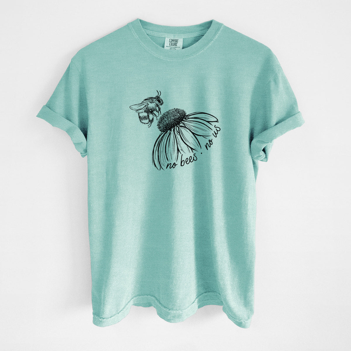 Chalky mint Comfort Colors t-shirt laid flat, printed with a black ink illustration of a bee flying toward a coneflower, with the handwritten words no bees no us.