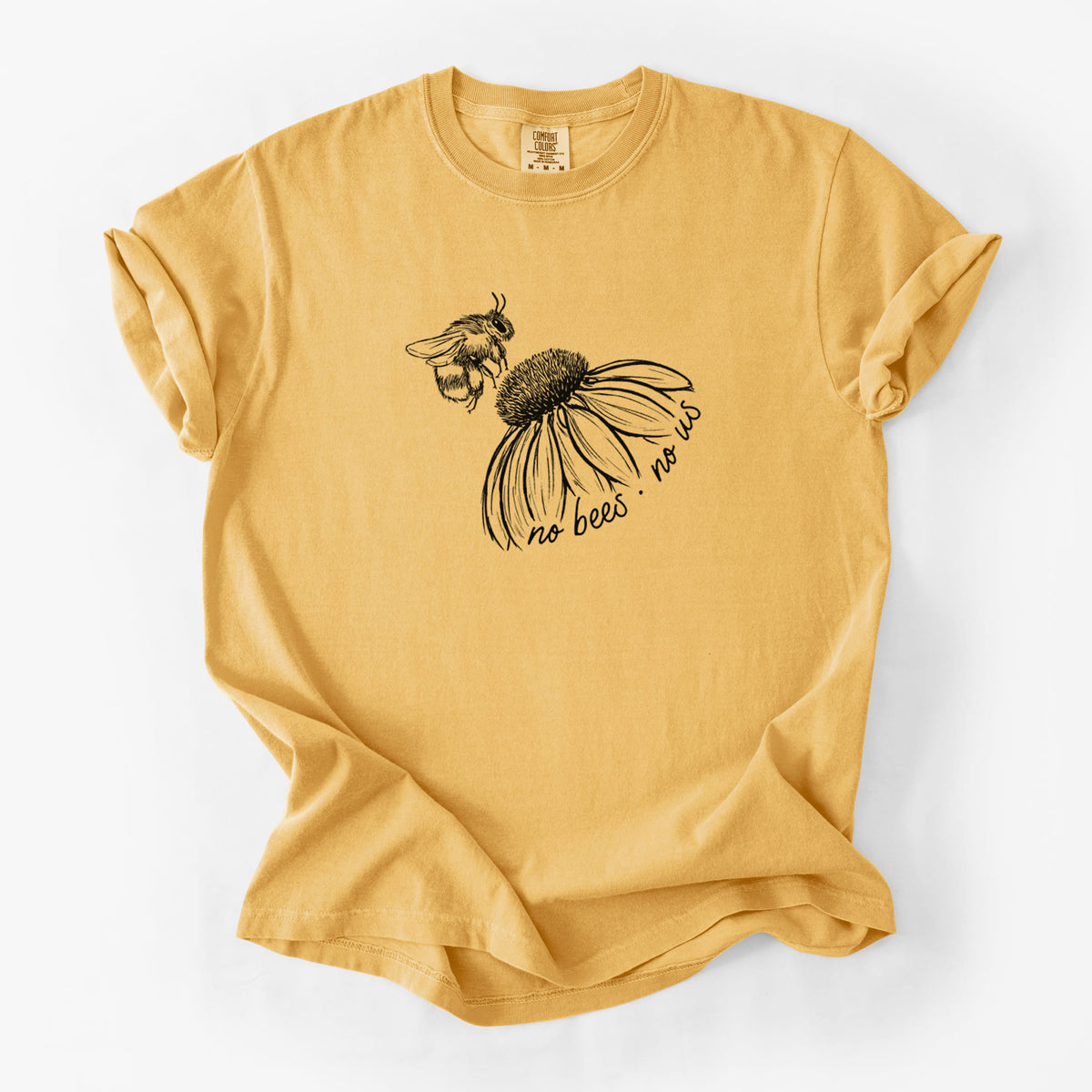 Golden wheat yellow Comfort Colors t-shirt laid flat, printed with a black ink illustration of a bee flying toward a coneflower, with the handwritten words no bees no us.