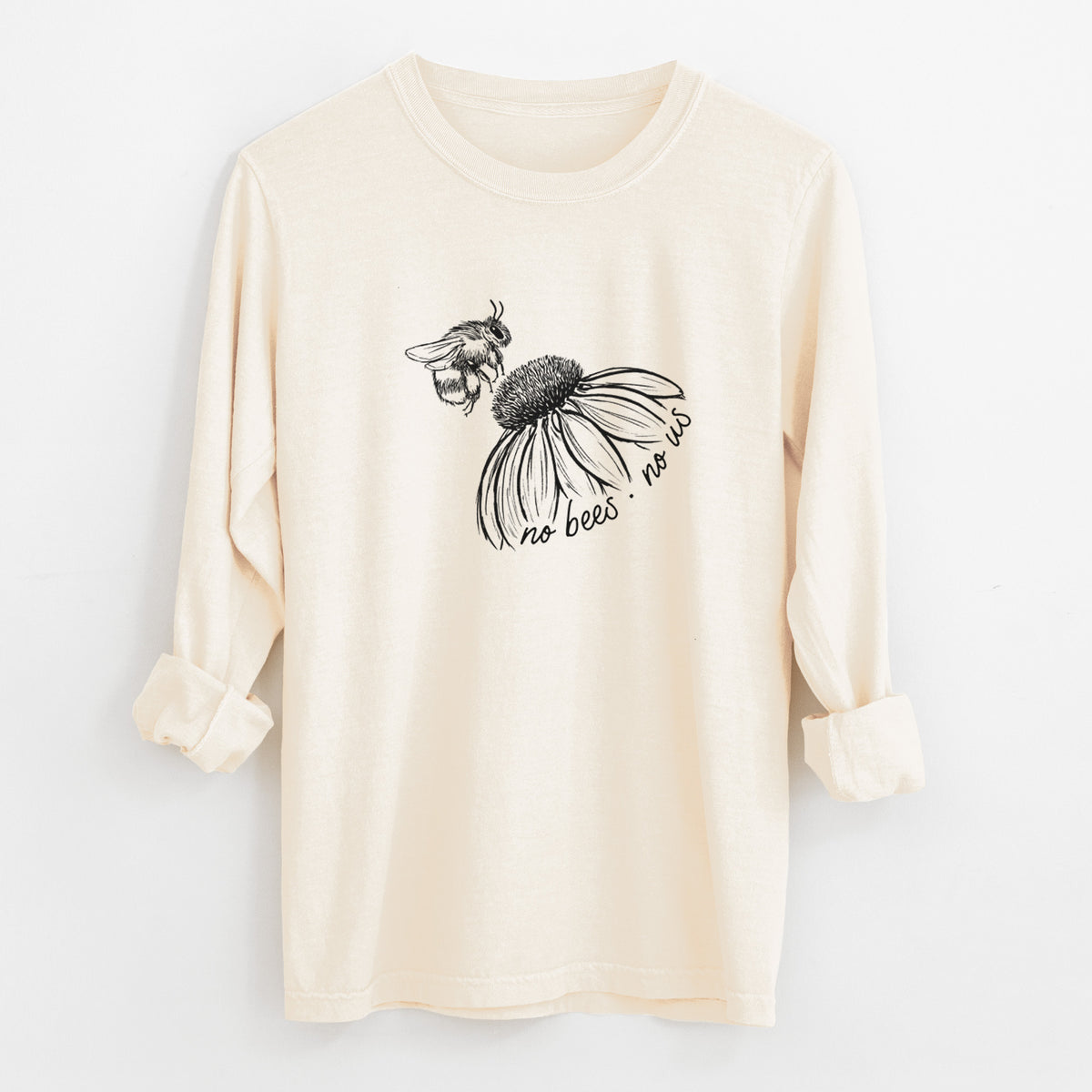 Ivory Comfort Colors long sleeve shirt laid flat with the cuffs rolled, printed with a black ink illustration of a bee flying toward a coneflower, with the handwritten words no bees no us.