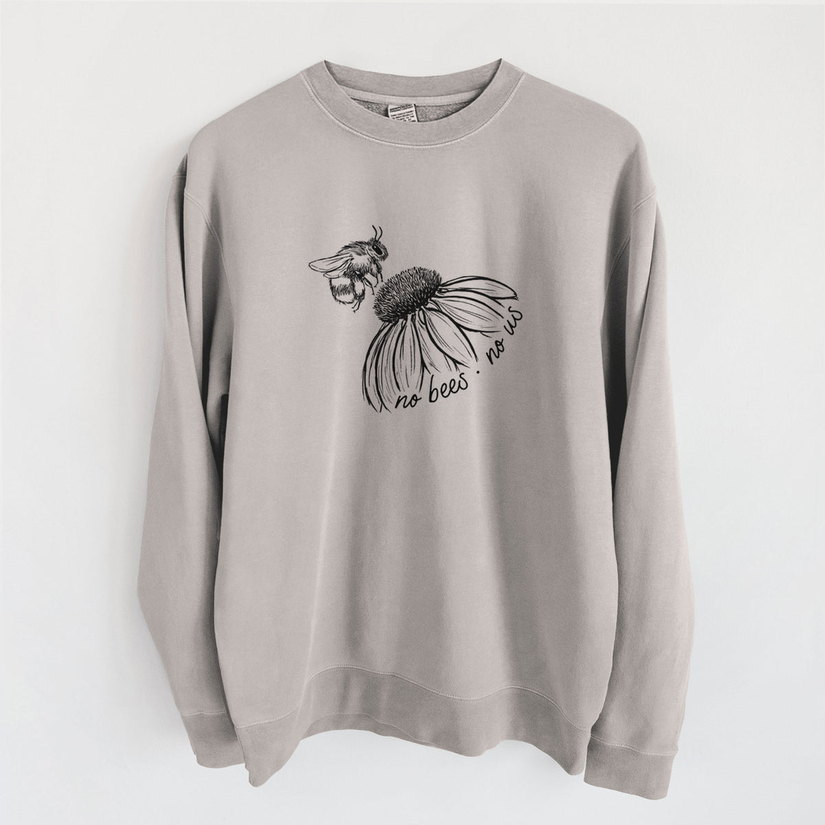 Cement grey pigment dyed crewneck sweatshirt laid flat, printed with a black ink illustration of a bee flying toward a coneflower, with the handwritten words no bees no us.