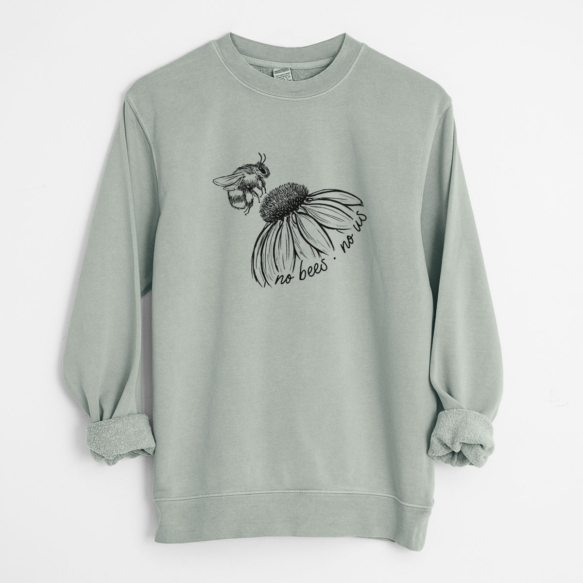 Sage green pigment dyed crewneck sweatshirt laid flat with the sleeves rolled, printed with a black ink illustration of a bee flying toward a coneflower, with the handwritten words no bees no us.
