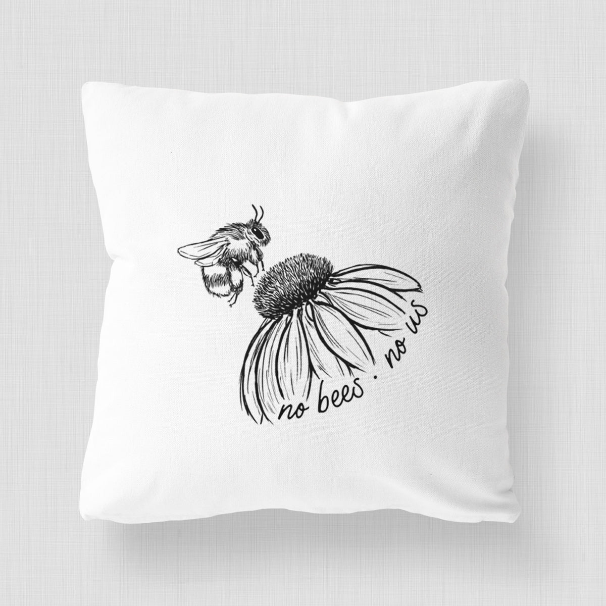 White pillow cover printed with a black ink illustration of a bee flying toward a coneflower, with the handwritten words no bees no us.
