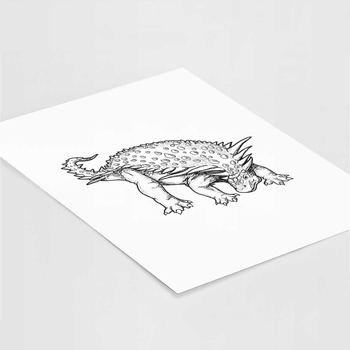 Art print of a black ink illustration of an armored Nodosaurus, lying at an angle on a white surface.