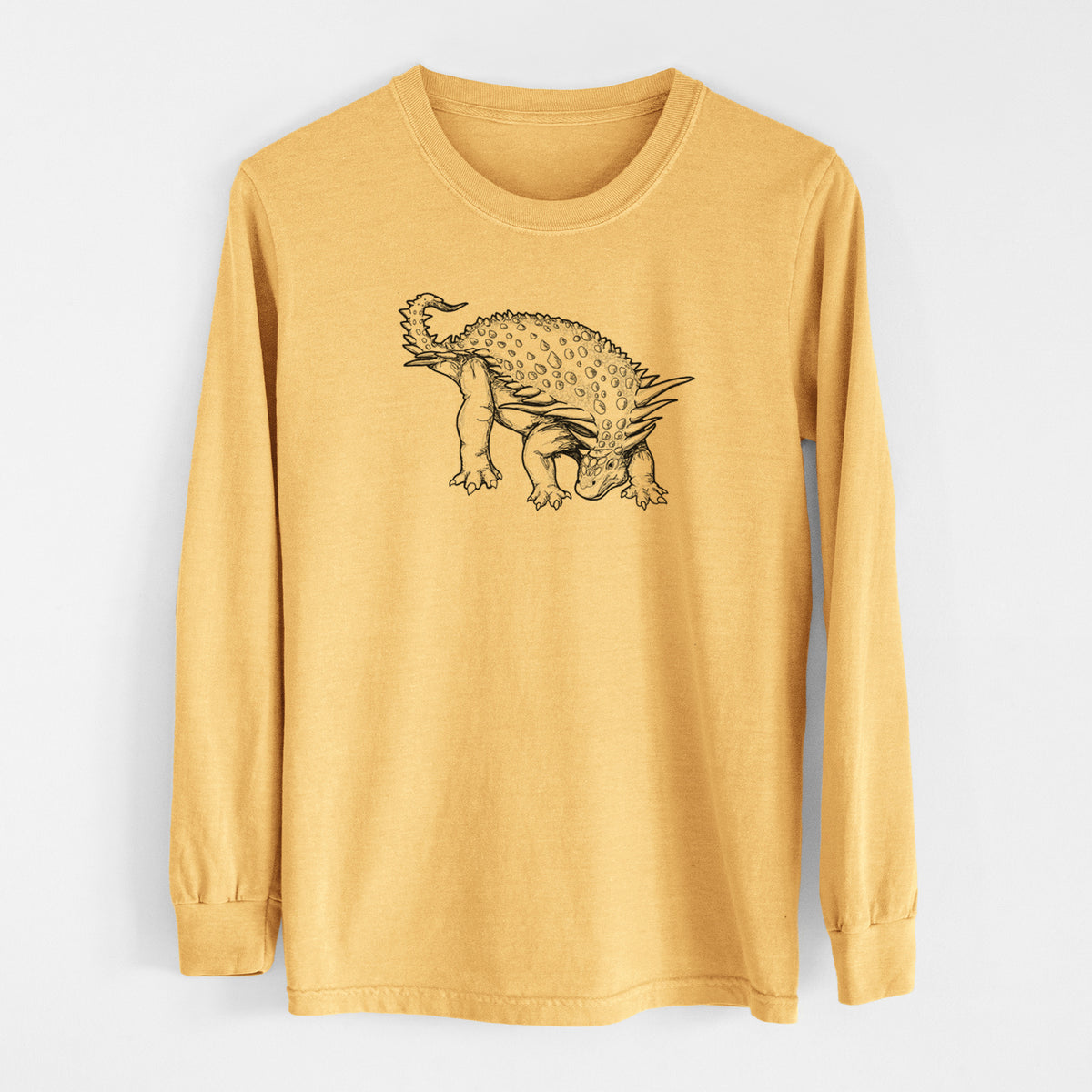 Golden wheat yellow Comfort Colors long sleeve shirt laid flat, printed with a black ink illustration of an armored Nodosaurus.