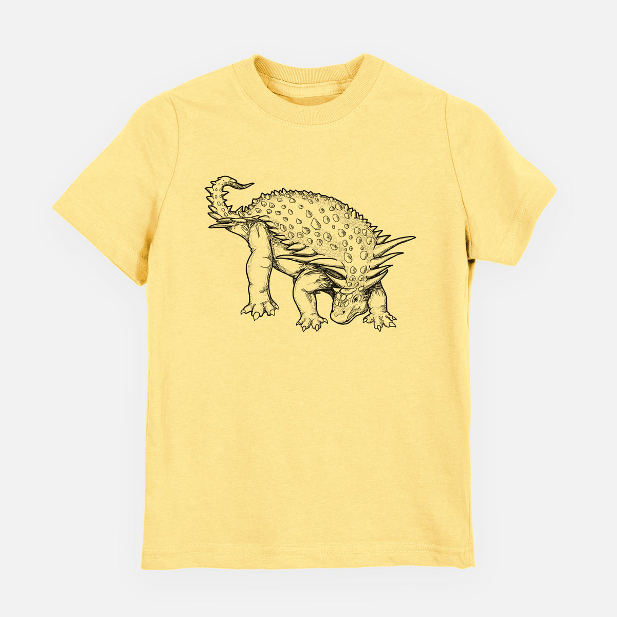 Butter yellow youth t-shirt laid flat, printed with a black ink illustration of an armored Nodosaurus.