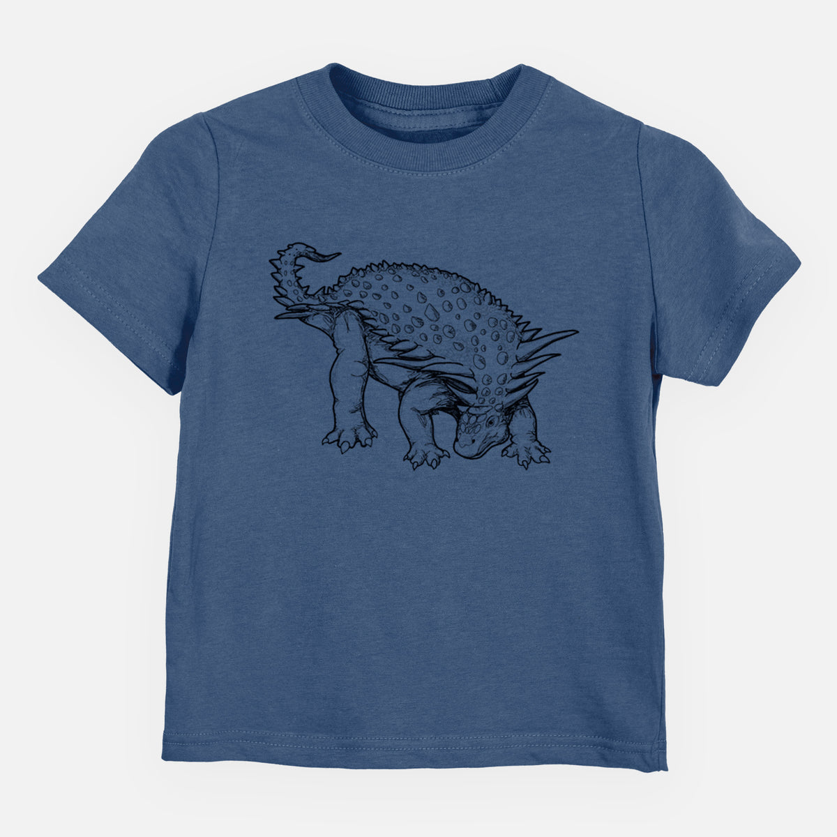 Indigo blue toddler t-shirt laid flat, printed with a black ink illustration of an armored Nodosaurus.