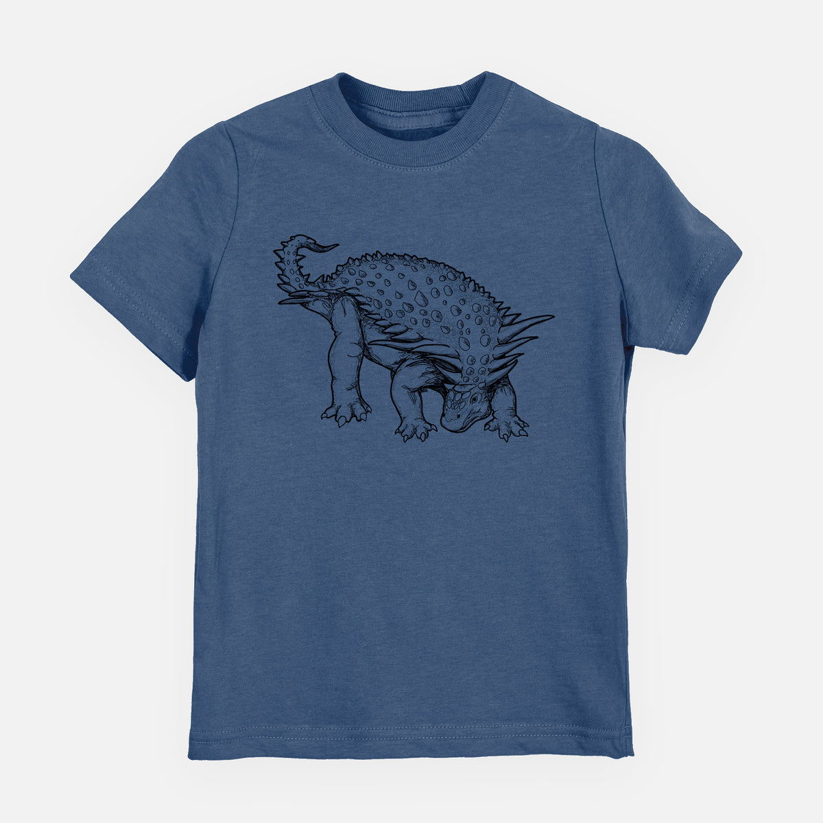 Indigo blue youth t-shirt laid flat, printed with a black ink illustration of an armored Nodosaurus.